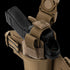 The Condor LCS RDS Leg Holster securely holds a black handgun with mounted sight in a tan tactical holster with strap and Velcro closure, ideal for law enforcement or military professionals.